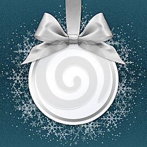 Christmas ball with silver satin ribbon bow on blue