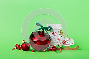 Christmas ball with skates on colored background. decoration bauble with ribbon bow with copy space