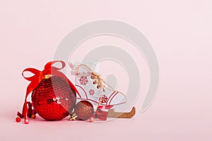 Christmas ball with skates on colored background. decoration bauble with ribbon bow with copy space