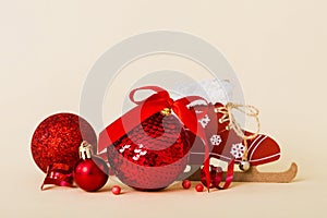 Christmas ball with skates on colored background. decoration bauble with ribbon bow with copy space