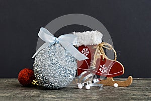 Christmas ball with skates on colored background. decoration bauble with ribbon bow with copy space
