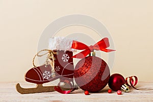 Christmas ball with skates on colored background. decoration bauble with ribbon bow with copy space