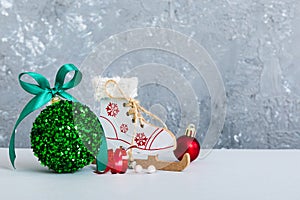 Christmas ball with skates on colored background. decoration bauble with ribbon bow with copy space