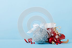 Christmas ball with skates on colored background. decoration bauble with ribbon bow with copy space