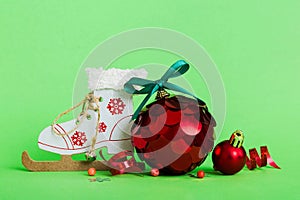 Christmas ball with skates on colored background. decoration bauble with ribbon bow with copy space