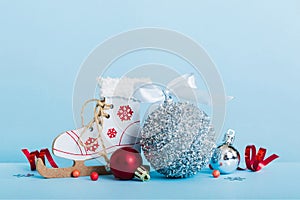 Christmas ball with skates on colored background. decoration bauble with ribbon bow with copy space