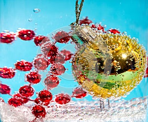 Christmas ball in water with bubbles, Christmas card concept