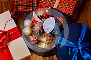 Christmas balls in a box with a gift with ribbons in a happy new