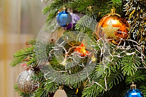 Christmas balls on branches of artificial holiday Christmas tree