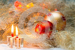 Christmas balls with candles on the background lights