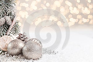 Christmas balls and fir branches with stars against a gold Blurred background