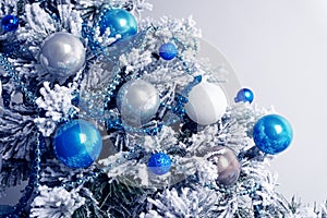 Christmas balls on fir tree. Blue and white. New Year holidays and Christmastime celebration