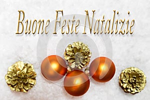 christmas balls and golden for cones in the snow, italian words, christmas holidays photo