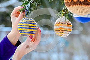 Christmas balls hanging on pine branches covered with snow