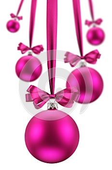 Christmas balls hanging pink ribbons on holiday.