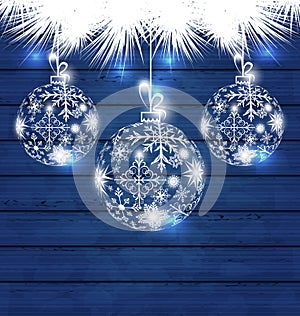 Christmas balls made in snowflakes on blue wooden background