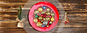 Christmas balls ornaments on red plate. Horizontal long frame.