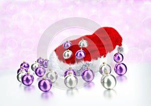 Christmas balls with santa red hat on bokeh background. 3D illustration