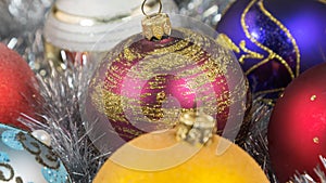 Christmas balls on a silver tinsel background. Christmas toy with christmas tinsel. Christmas decorations.