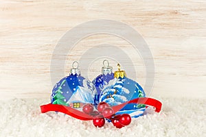 Christmas balls and snowflake on wooden background