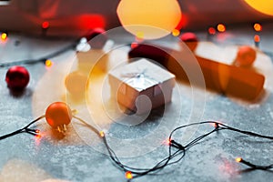 Christmas balls and white vinous gift boxes form the decoration of the Christmas tree, in the background in the form of