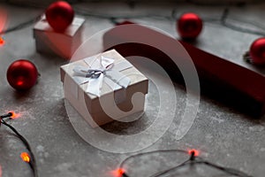 Christmas balls and white vinous gift boxes form the decoration of the Christmas tree, in the background in the form of a bokeh