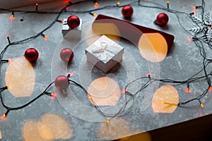 Christmas balls and white vinous gift boxes form the decoration of the Christmas tree, in the background in the form of a bokeh