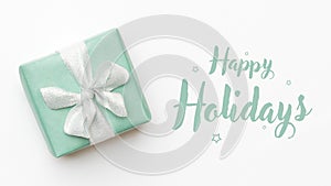 Christmas banner. Beautiful christmas gift isolated on white background. Turquoise colored wrapped xmas box. Gift wrapping.