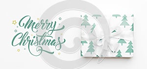 Christmas banner. Beautiful christmas gift isolated on white background. Turquoise colored wrapped xmas box. Gift wrapping.