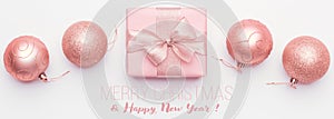 Christmas banner. Beautiful pink christmas gift and ornament baubles isolated on white background.