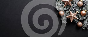 Christmas banner. Black Xmas background with pine tree branch decorated cooper color balls and stars. Christmas frame, greeting