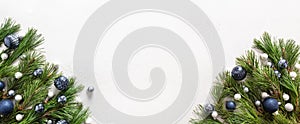 Christmas banner with blue balls and evergreen branches on white. Xmas Greeting card. Copy space