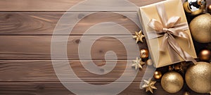Christmas banner on brown wooden background with gift. Xmas decoration top view with copy space