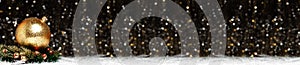 Christmas banner decorations view of gold evening ball with gold glitter on it in christmas wreath with red berries on dark