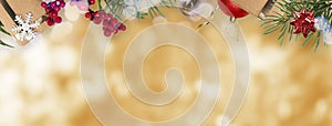 Christmas banner with gifts and decorations, copy space on the golden bokeh background. Wide format, top border