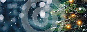 Christmas banner. Green pine tree branches with golden garland lights on blurred falling snow background