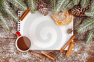 Christmas banner with green tree, cones, red cups with hot chocolate, orange and cinnamon on brown wooden background