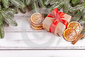 Christmas banner with green tree, giftbox, handmade felt decoration, orange and cinnamon on white wooden background