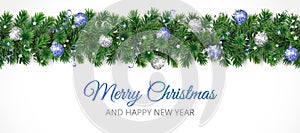 Christmas banner with Merry Christmas text and pine tree garland isolated on white. Blue and silver ornaments.