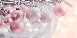 Christmas banner with pink and silver tree bauble ornaments and snow covered tree