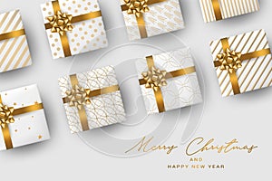 Christmas banner or poster design. Xmas gift boxes. Winter celebration concept. Golden ribbon and bow on white wrapping paper.
