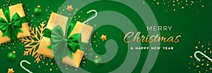 Christmas banner. Realistic gold gift boxes with green bow, gold stars, shiny golden snowflake, balls and candy canes. Xmas green