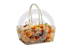 Christmas basket with fresh clementines , nuts and cookies.