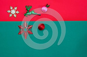 Christmas bauble,snow flake ,presents ,reindeer and leaves on Red green background with snow fall,top  view with copy space