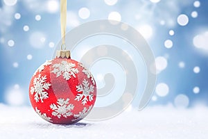 Christmas bauble on a snowy winter background, Merry Christmas and Happy Holidays wishes, generative ai