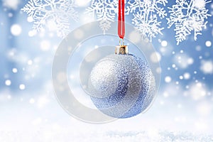 Christmas bauble on a snowy winter background, Merry Christmas and Happy Holidays wishes, generative ai