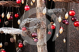 Christmas Baubles Balls and wreath hanging on pine tree branches outside