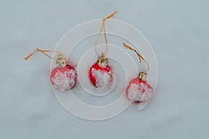 Christmas baubles covered with snow