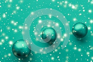 Christmas baubles on green background with snow glitter, luxury winter holiday card