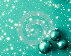 Christmas baubles on green background with snow glitter, luxury winter holiday card